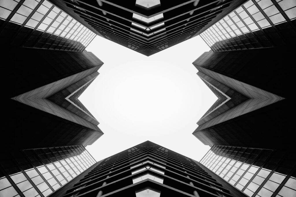 Symmetrical view of modern skyscrapers against sky
